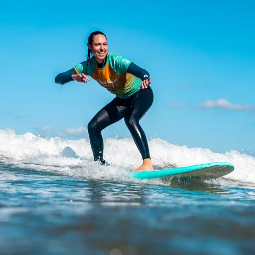 girl surfing having fun in our Surf Camp in Famara