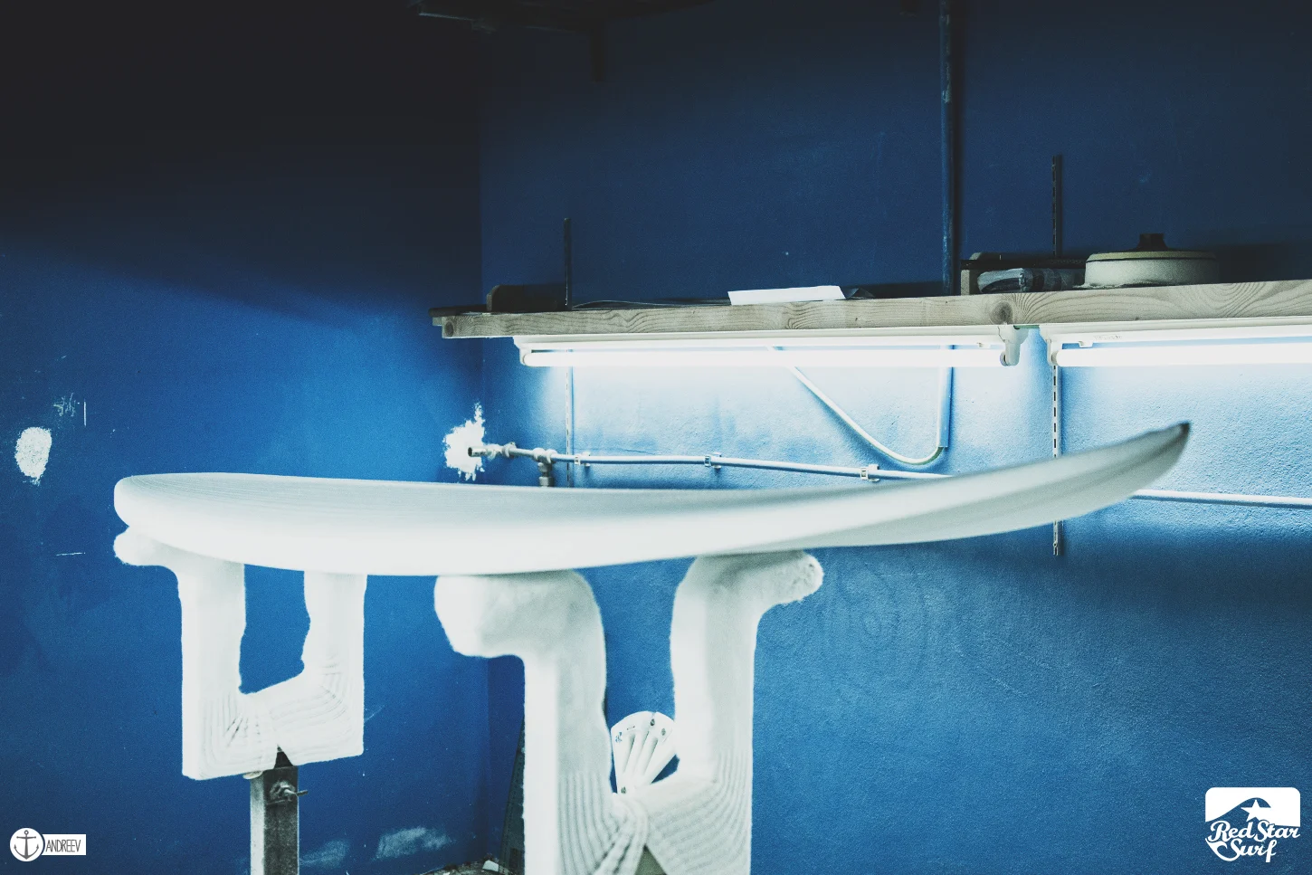 Freshly shaped surfboard blank on the racks in a Lanzarote shaping room
